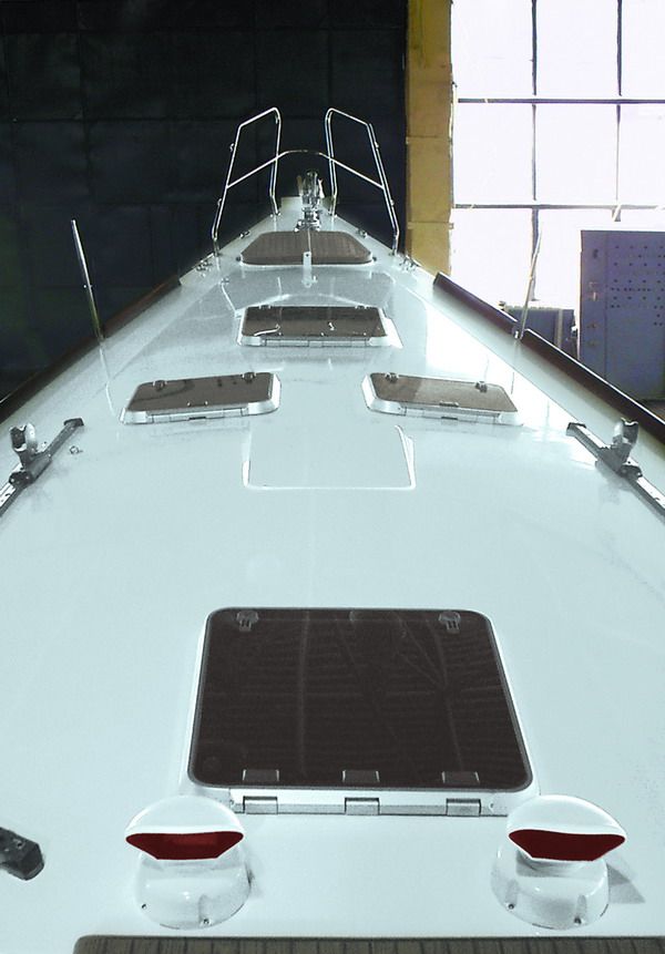 The foredeck looking forward — flush Lewmar hatches, dorade vents and bow pulpit on the steel deck.